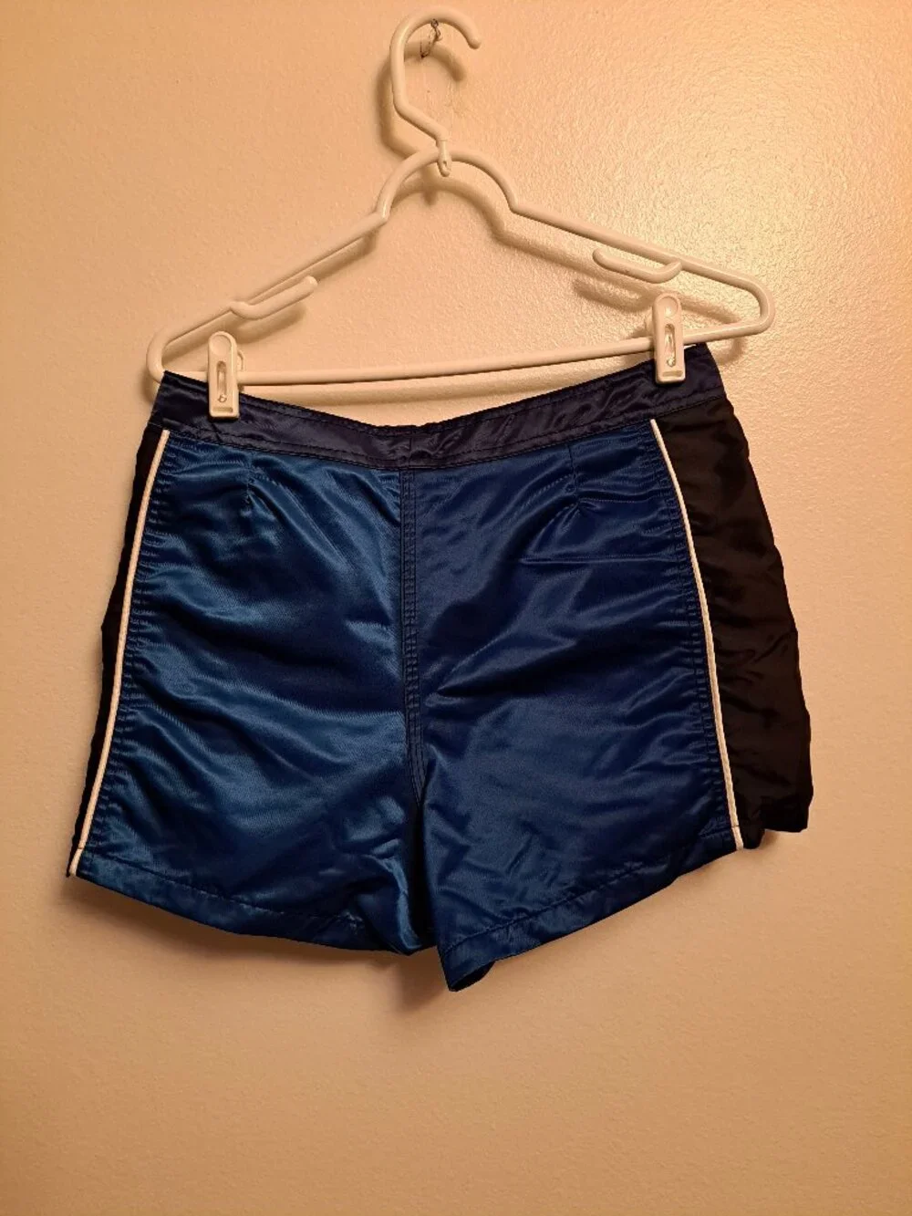 Vintage Fox Racing board shorts featuring a blue satin finish &white piping.